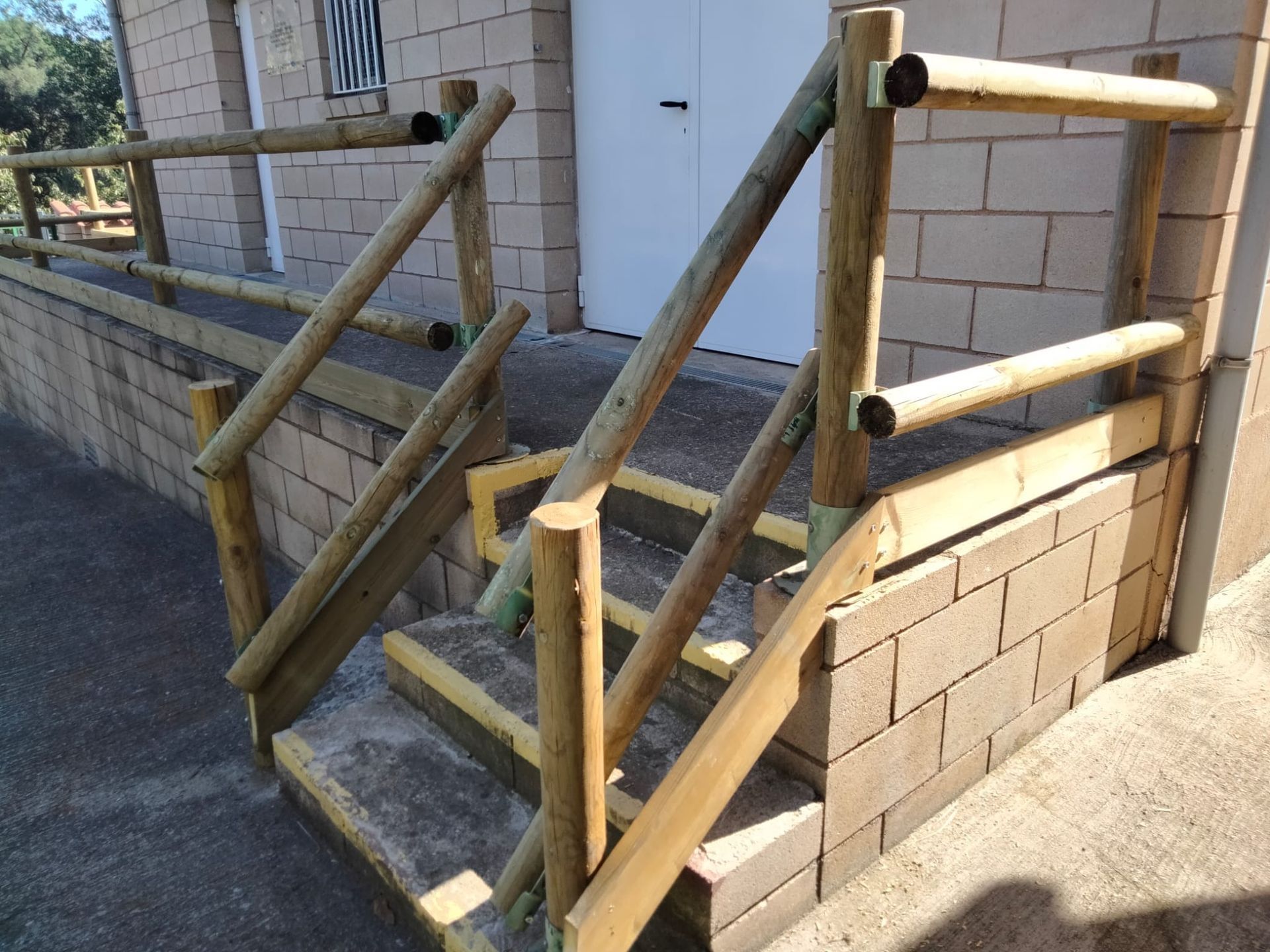 Un conjunto de escaleras de madera que conducen a un edificio de ladrillo.