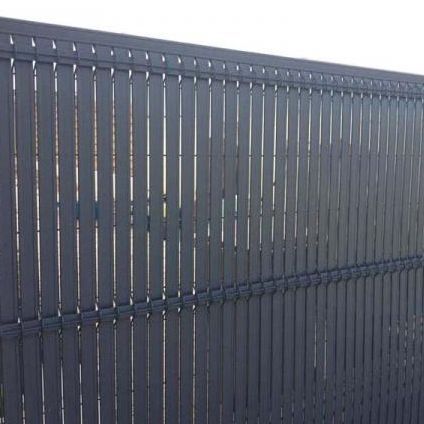 Un primer plano de una valla negra con un fondo blanco.