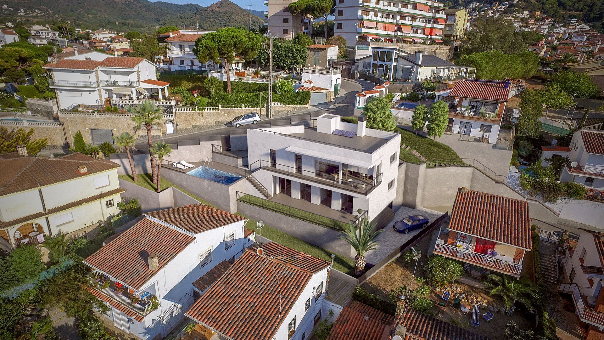 Una vista aérea de una casa con piscina en medio de una zona residencial.