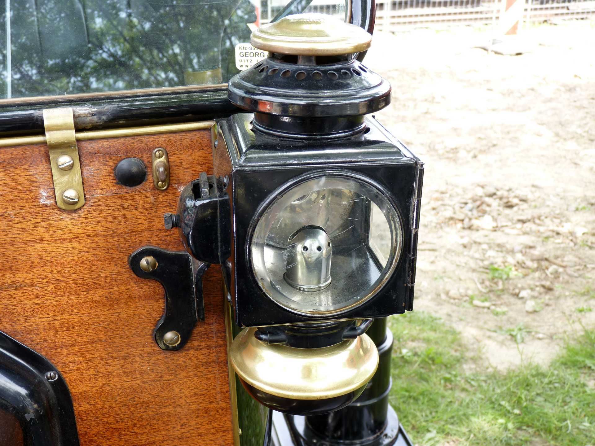 Eine Nahaufnahme einer Lampe an der Seite eines alten Autos.