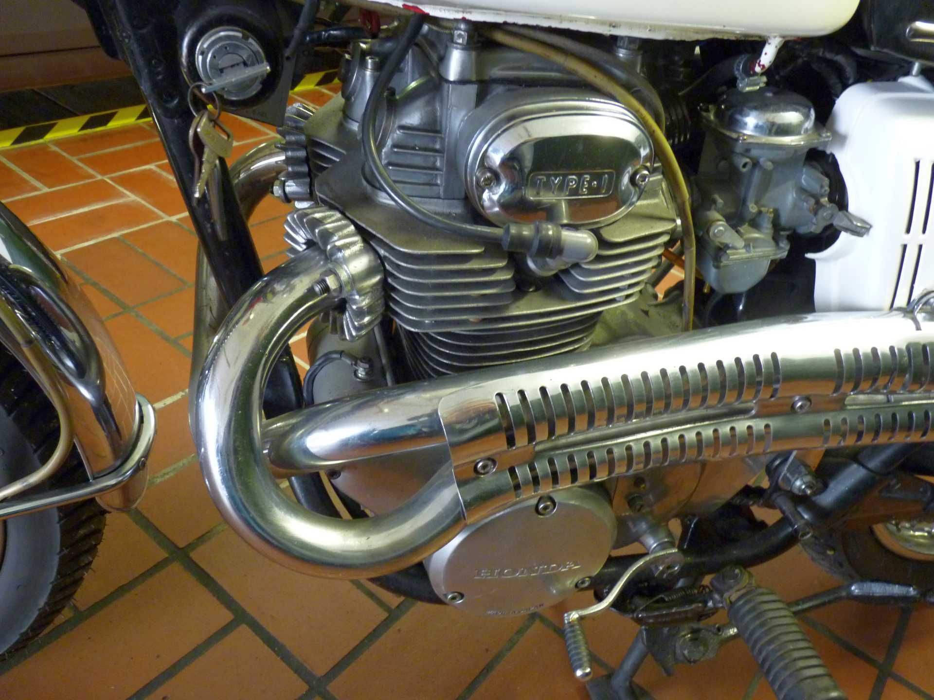 Eine Nahaufnahme eines Motorradmotors auf einem Fliesenboden