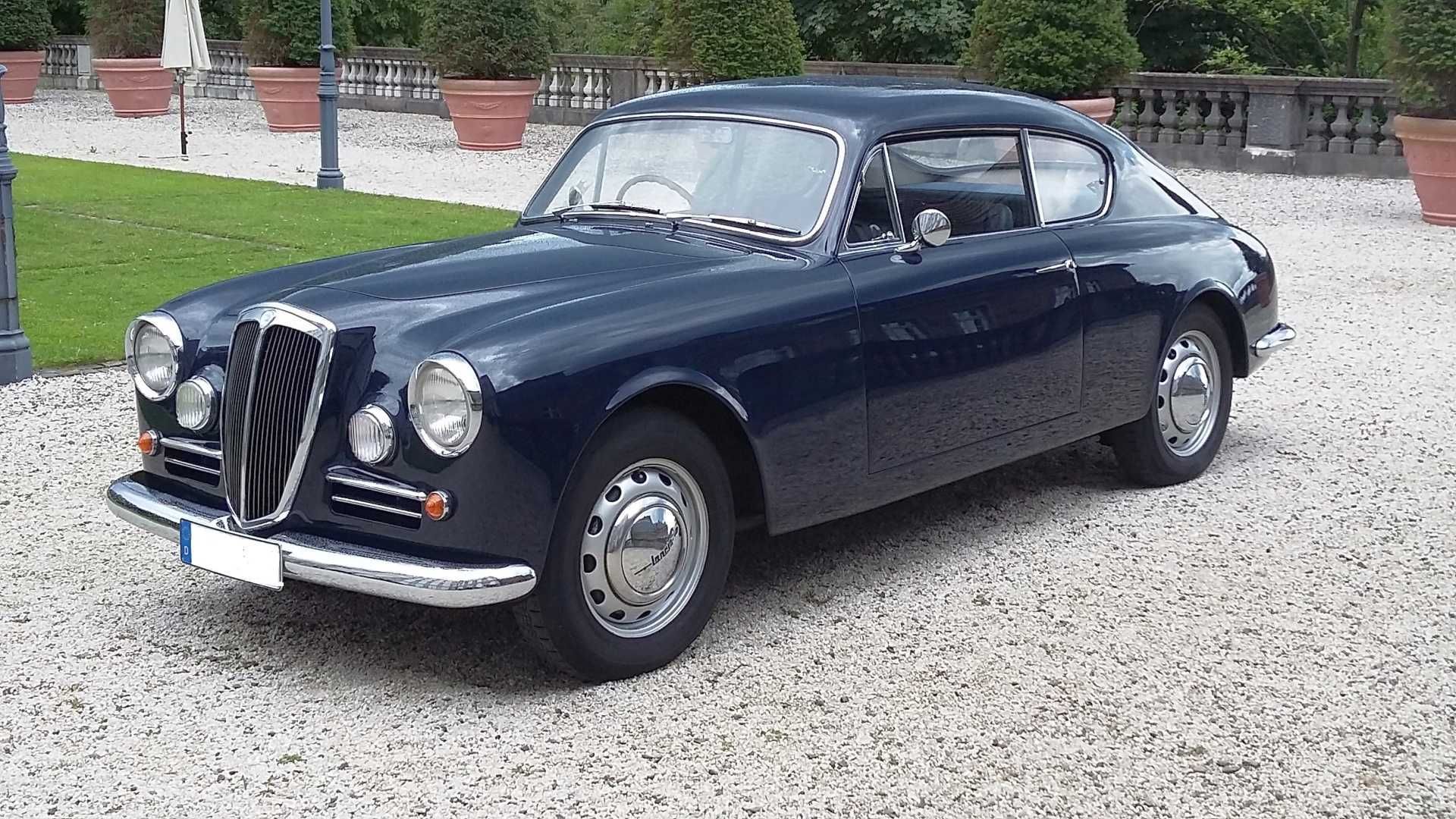 Ein blaues Auto steht auf einer Kiesauffahrt