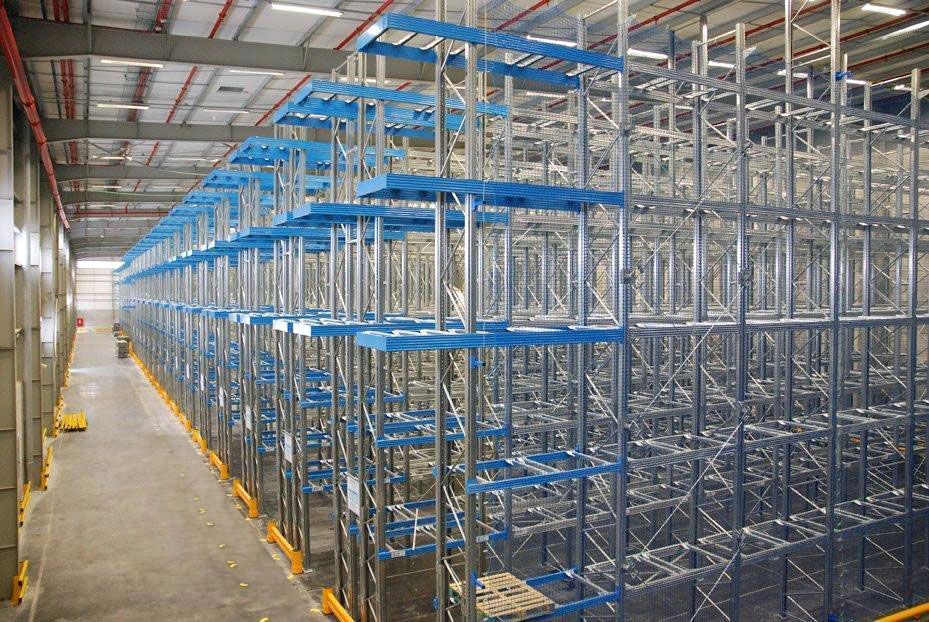 Un almacén lleno de estanterías y paletas.