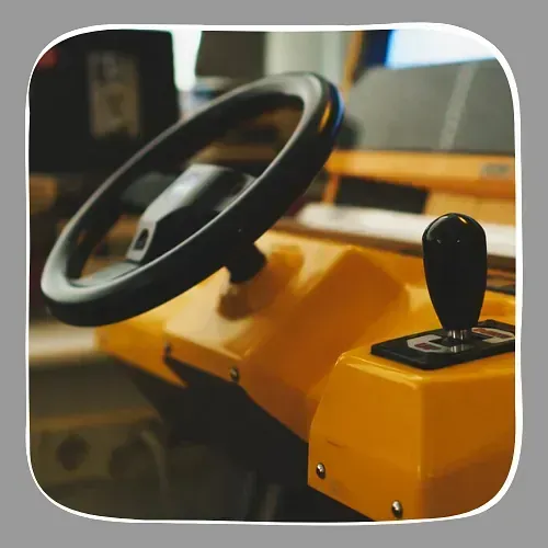Un coche amarillo con un volante negro y una palanca de cambios negra