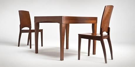 Mesa de comedor de madera con dos sillas a juego sobre fondo blanco