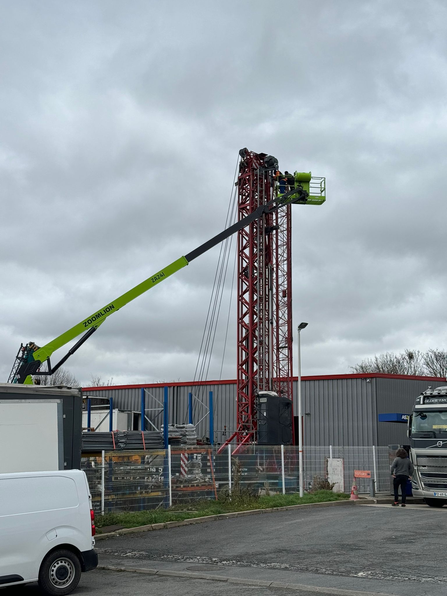 Nacelle télescopique au-dessus d'un entrepôt gris