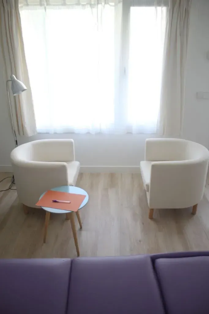 Hay dos sillas y una mesa en la habitación.