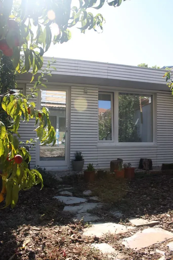 Una casa blanca con un árbol delante