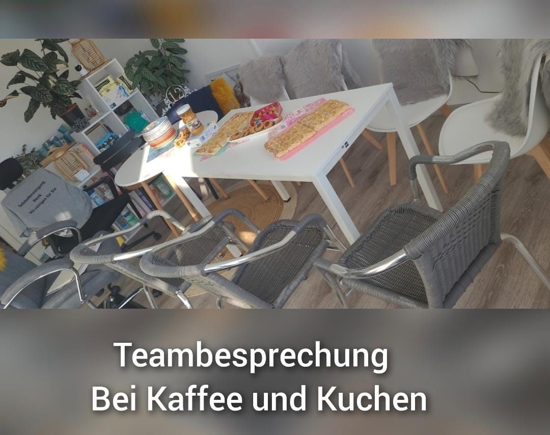 A room with a table and chairs and the words teambesprechung bei kaffee und kuchen