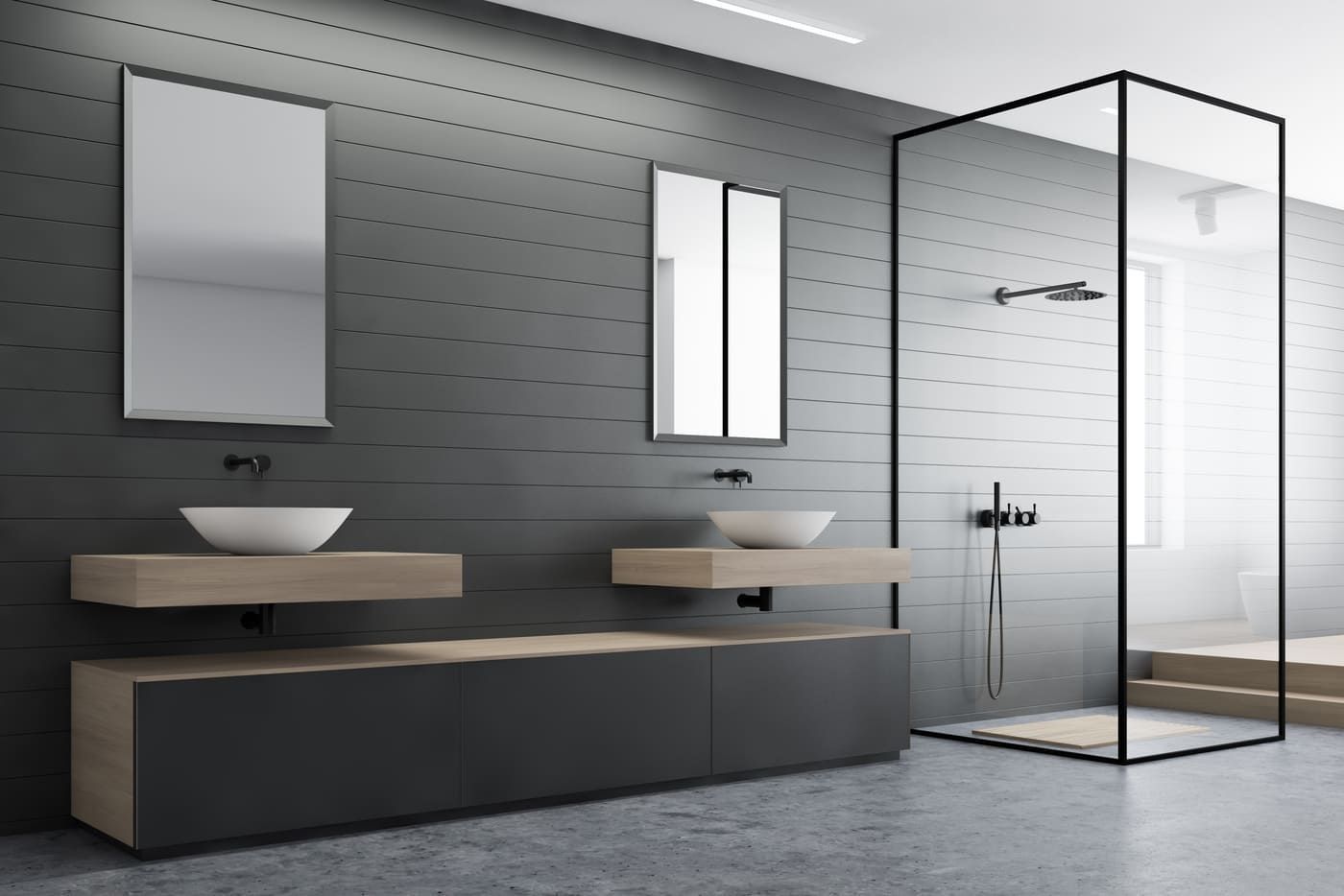 Baño moderno de color gris con lavabos murales, espejos y cabina de ducha de cristal.