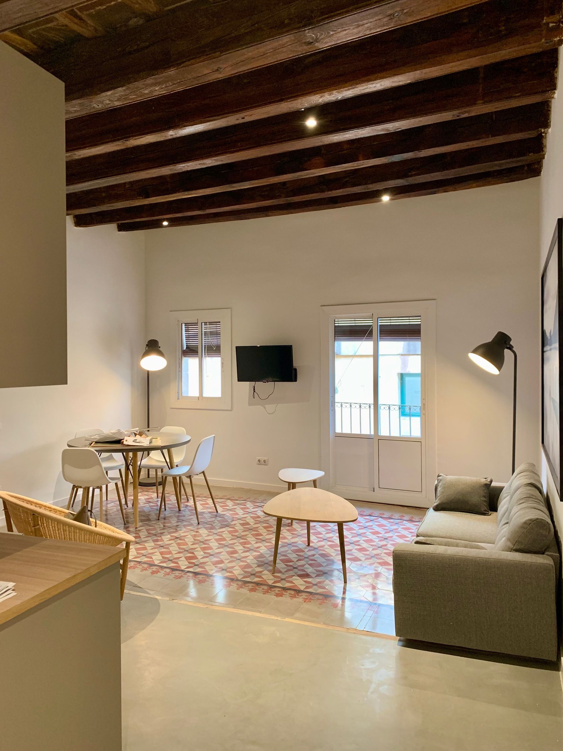 Una sala de estar con un sofá, una mesa y sillas.