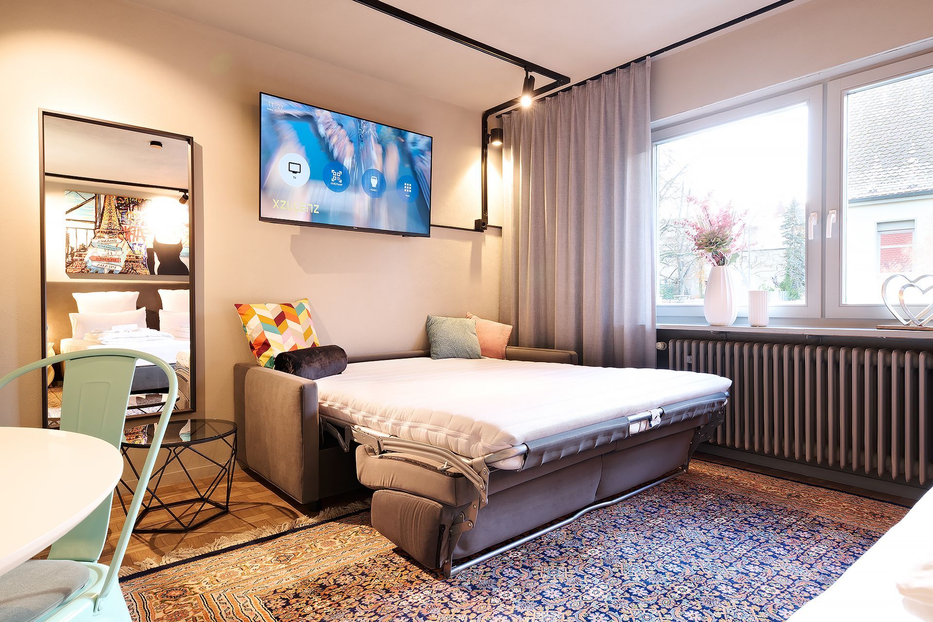 Ein Wohnzimmer mit einer Couch und einem Fernseher an der Wand.