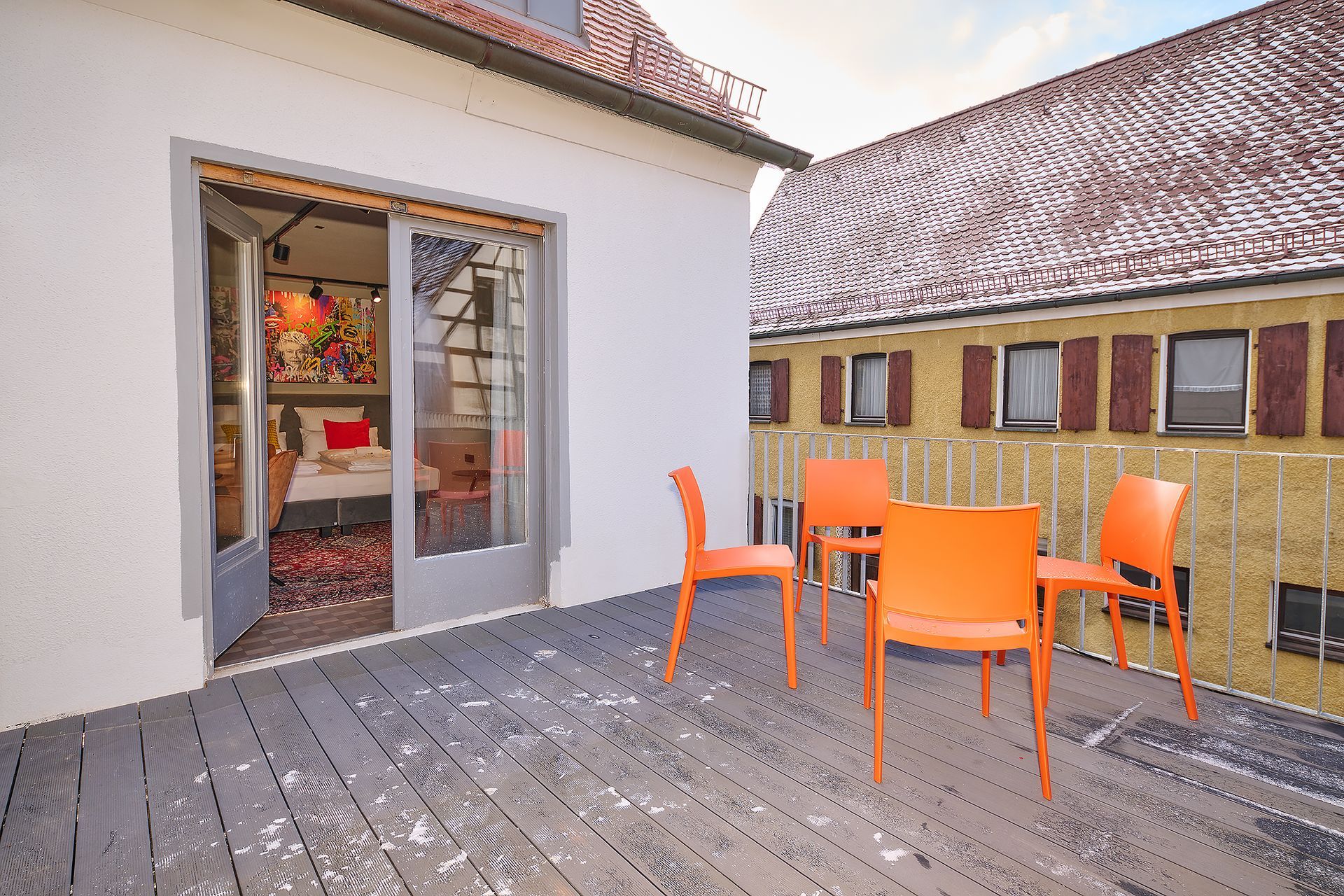 Ein Balkon mit Tisch und Stühlen vor einem Gebäude