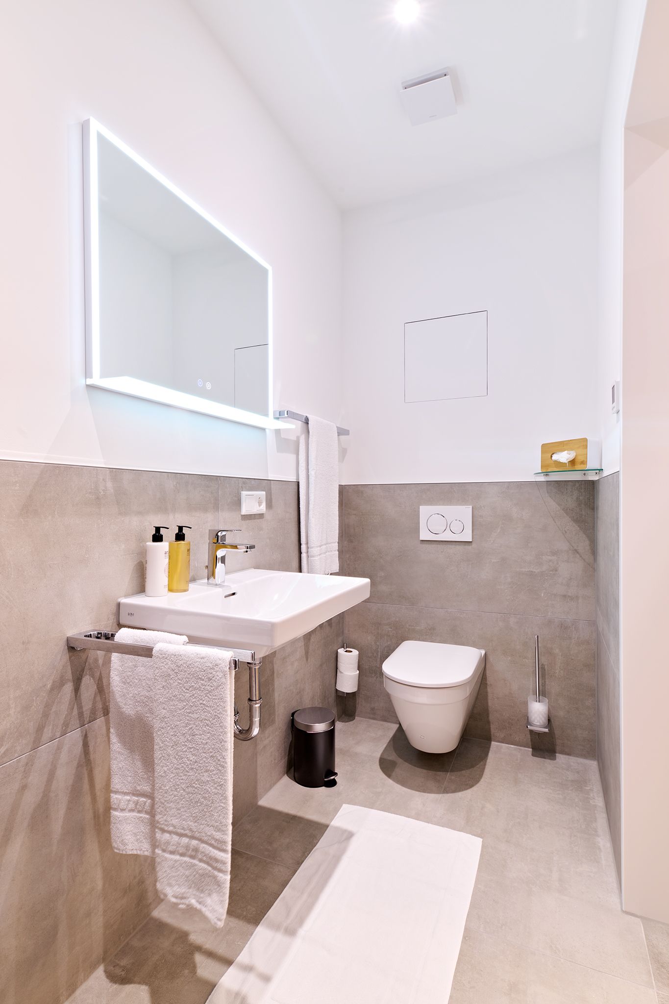 Ein Badezimmer mit Waschbecken, Toilette und Spiegel.