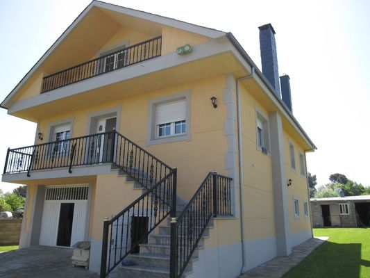 Una casa grande con escaleras que conducen al segundo piso.