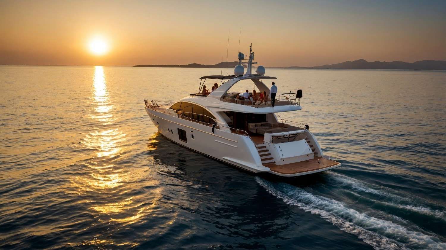 Yate blanco navegando por el océano al atardecer, gente visible en la cubierta.