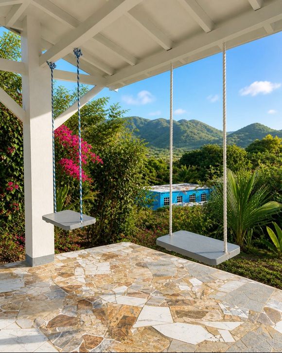 Porch swing overlooking tropical garden, blue pool, and green mountains under a bright sky at Chenko Villas + Rental Cars