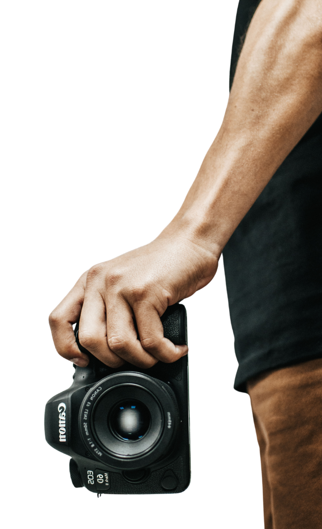 A person is holding a canon camera in their hand.