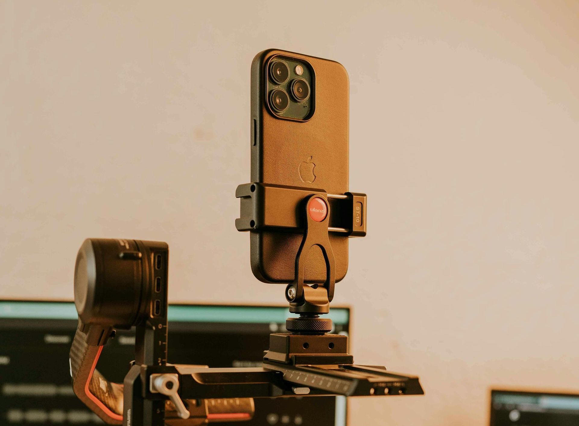 A cell phone is sitting on top of a gimbal.