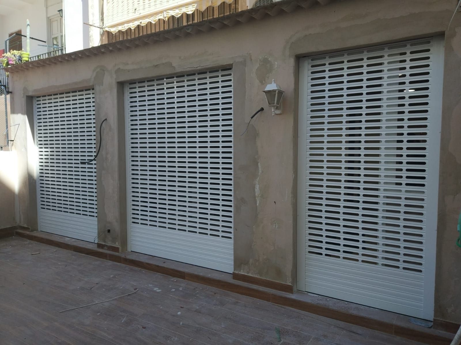 Una hilera de puertas de garaje blancas en un edificio.