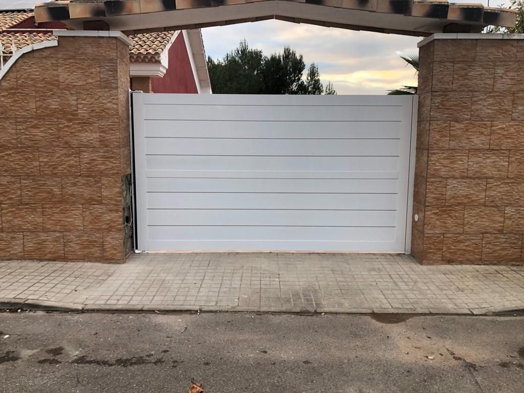 Una puerta blanca está situada frente a una pared de ladrillos.