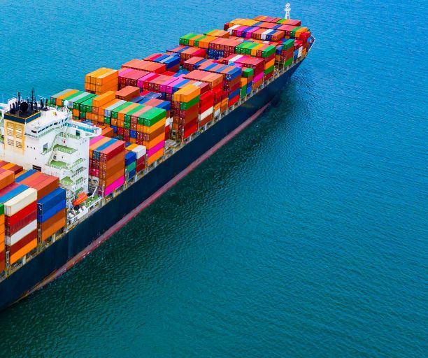A large container ship is floating on top of a body of water.
