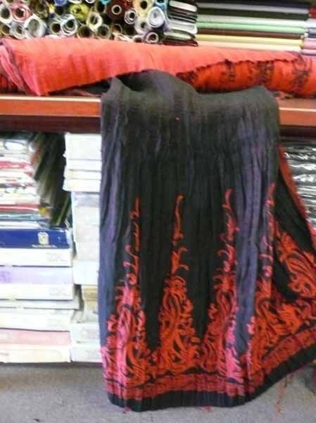 Una falda negra y roja está sobre una mesa.