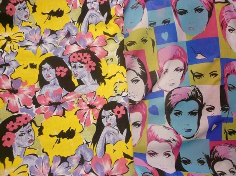 Una tela colorida con un patrón de rostros de mujeres y flores.