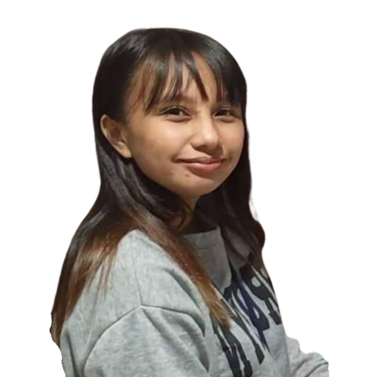 A young girl is wearing a gray sweatshirt and smiling.