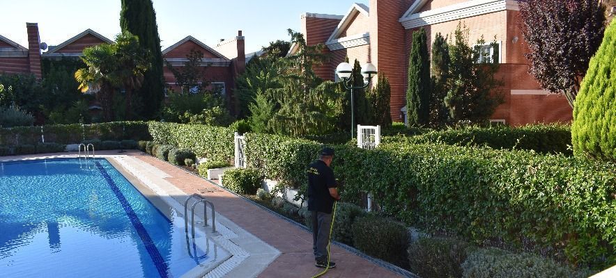 Un hombre está parado frente a una piscina.