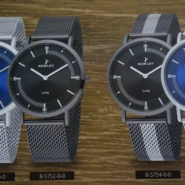 Un reloj Rowley está sobre una mesa de madera.