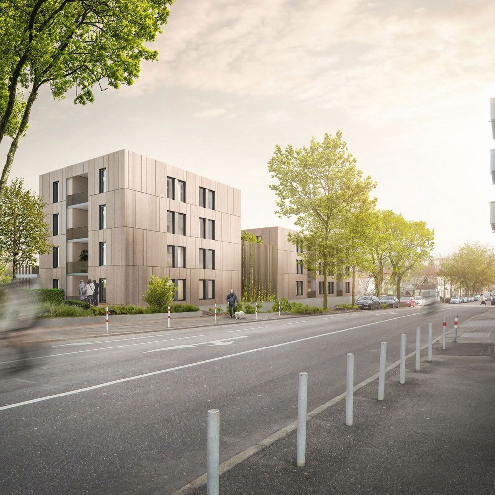 Moderne Wohnhäuser mit Balkonen an einer Straße mit Bäumen und Fußgängern.