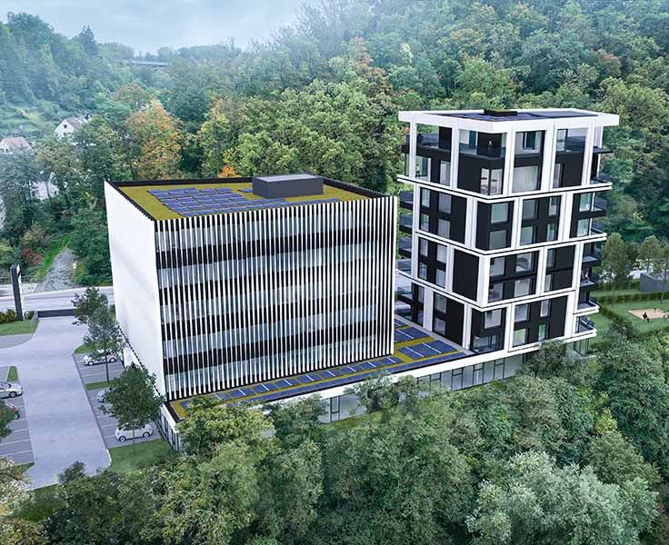 Moderne Bürogebäude mit weiß-schwarzer Fassade, umgeben von Bäumen.