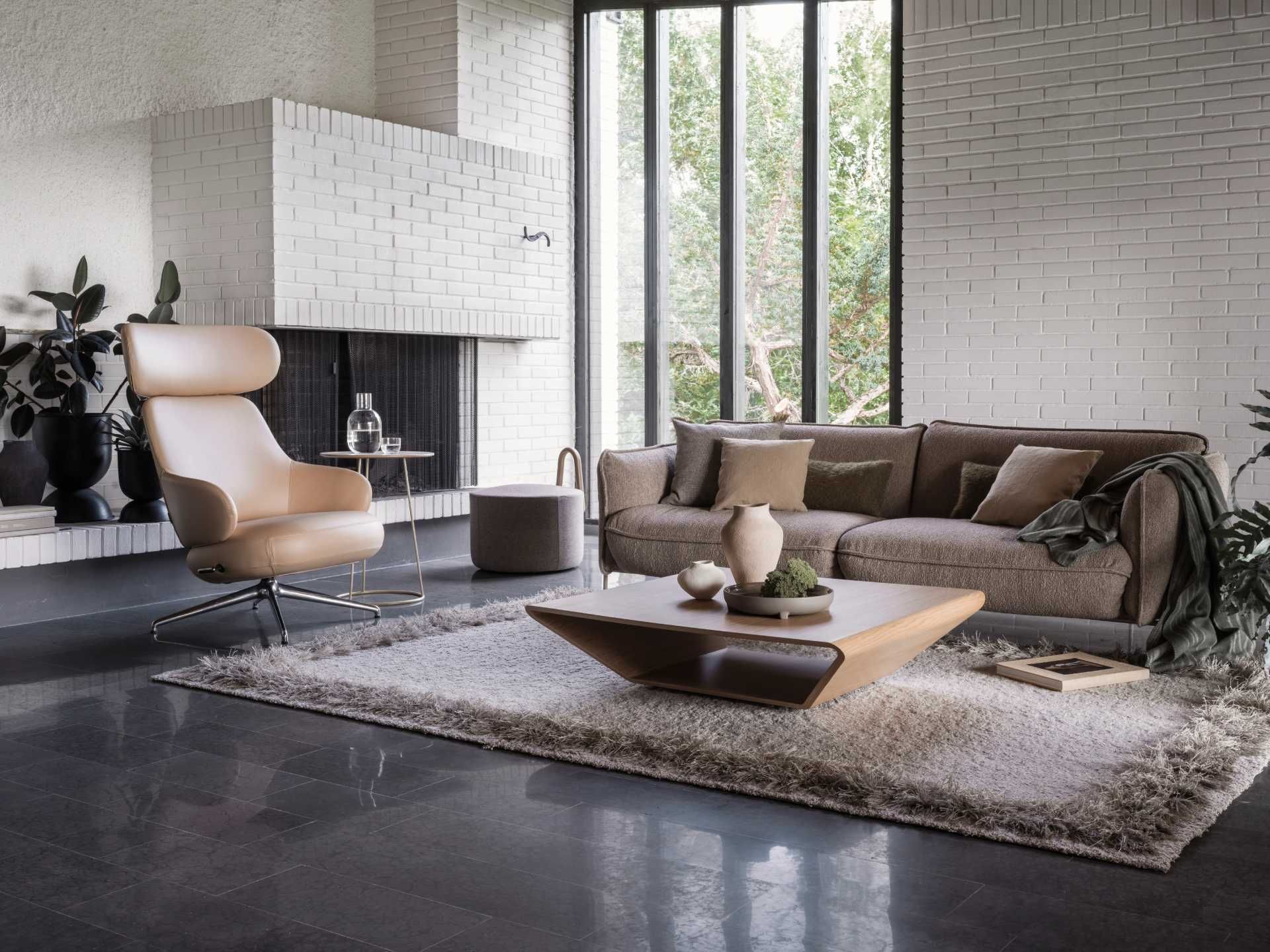 Elegantes Wohnzimmer mit beigem Sofa und Design-Sessel