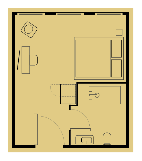 Floor plan of a square room with a bed, desk, small bathroom with toilet, sink, and shower, and a door.