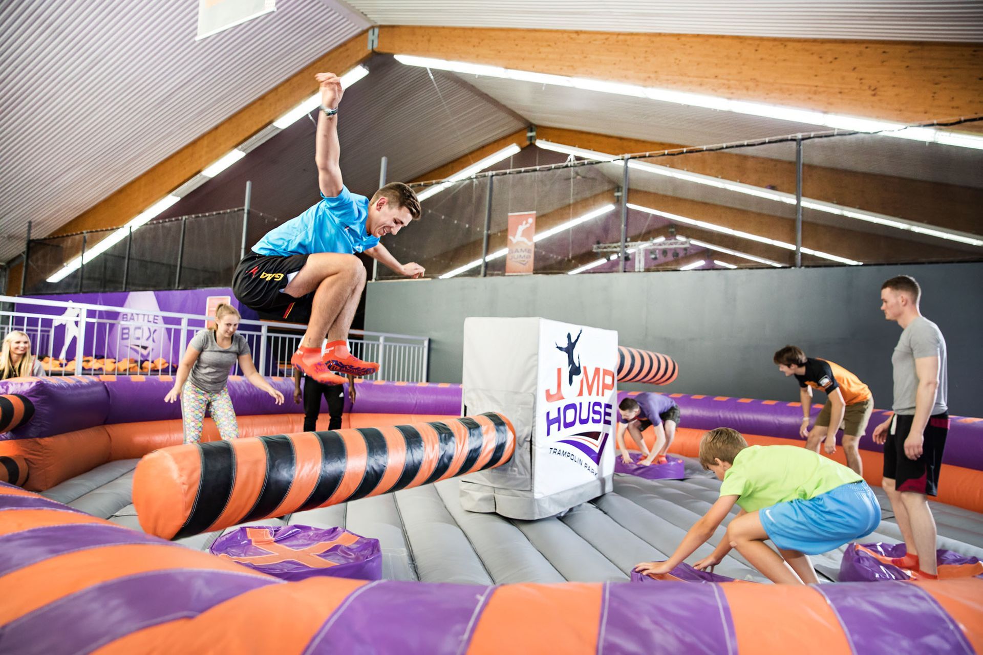 Eine Gruppe von Leuten spielt ein Spiel in einem Trampolinpark.