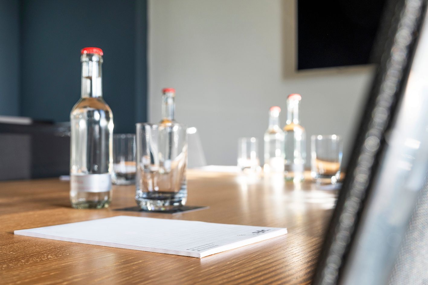 Ein langer Holztisch mit einer Vase mit Blumen darauf