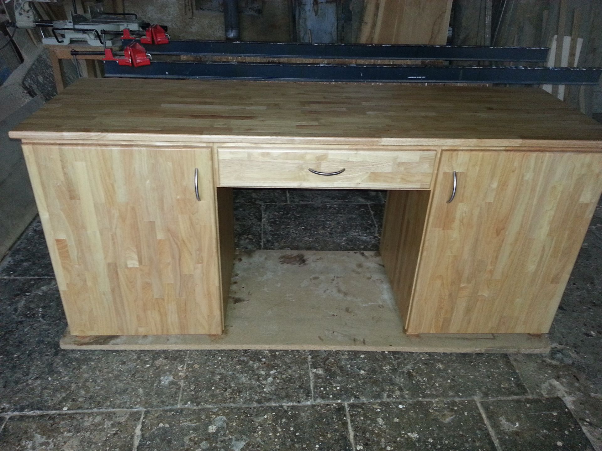 Meuble en bois avec un tiroir central et deux portes.