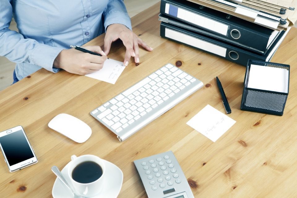 Ein Mann steht hinten in einem mit Pappkartons gefüllten Lieferwagen.