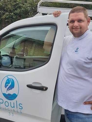 Un homme en chemise blanche se tient à côté d'une camionnette blanche portant le logo d'une entreprise de services de piscine.