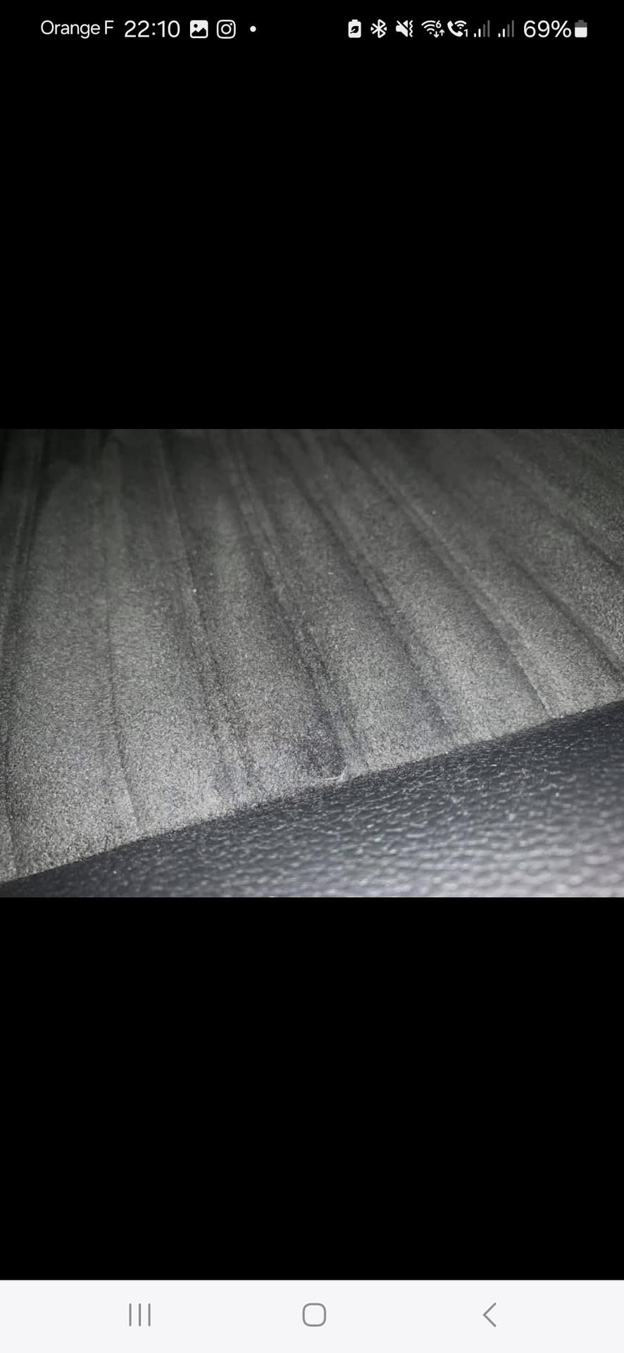 Tapis gris, perspective diagonale, avec des lignes distinctes et une ombre sombre.