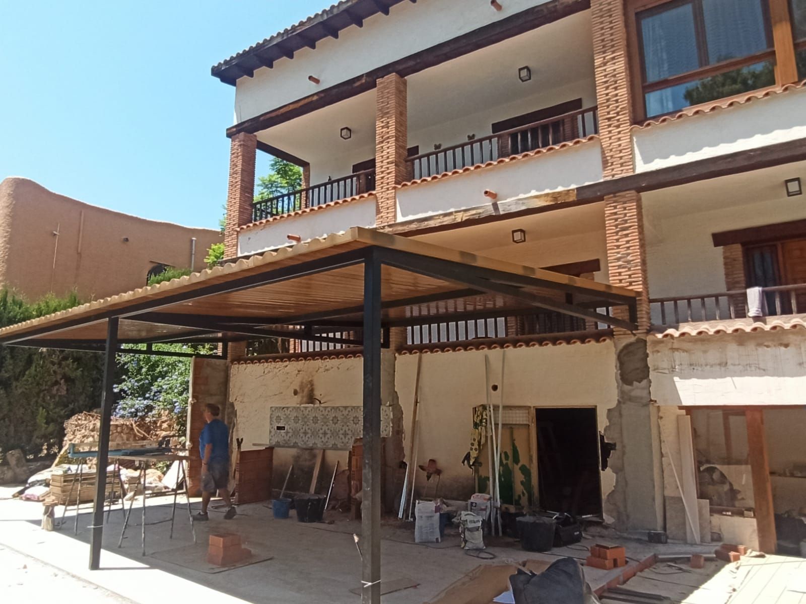 Ventana de madera con persianas abiertas, que deja ver una luminosa escena nevada en el exterior.