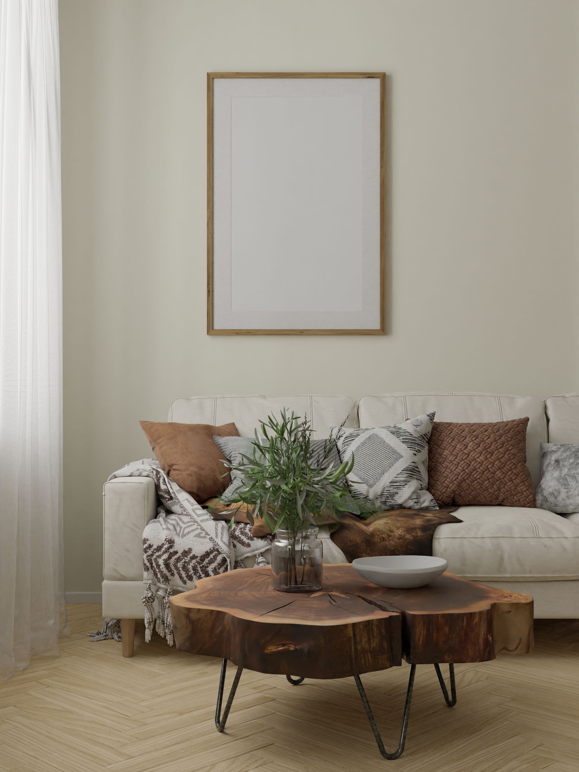 Un canapé et une table basse devant un mur peint en couleur claire ayant un cadre