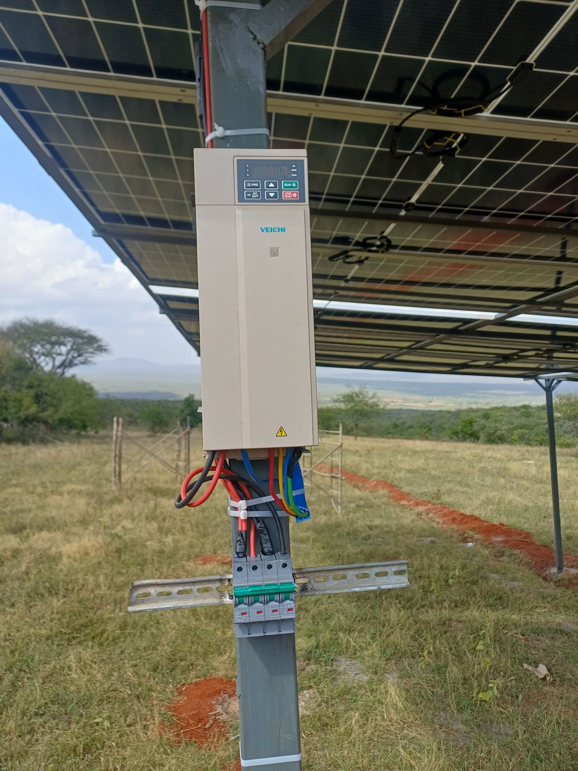 Blue vertical inline pump with motor and flanged connections.