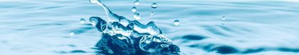 Water splashing upwards with droplets and ripples.