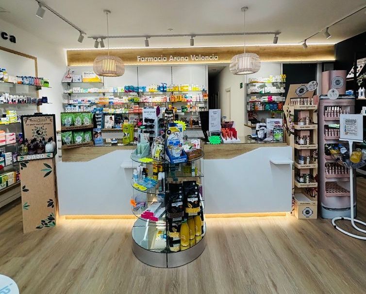 El interior de una farmacia con suelo de madera y mostrador.