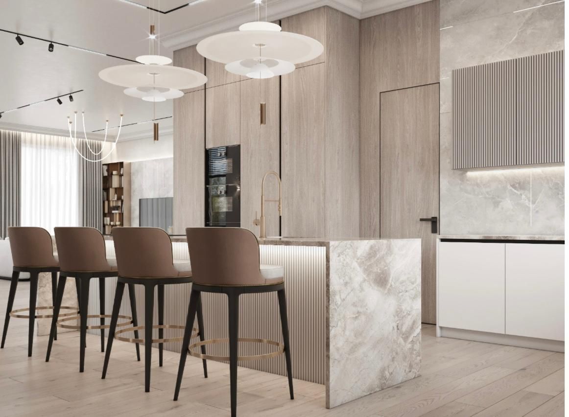 Una cocina con encimera de mármol y taburetes.