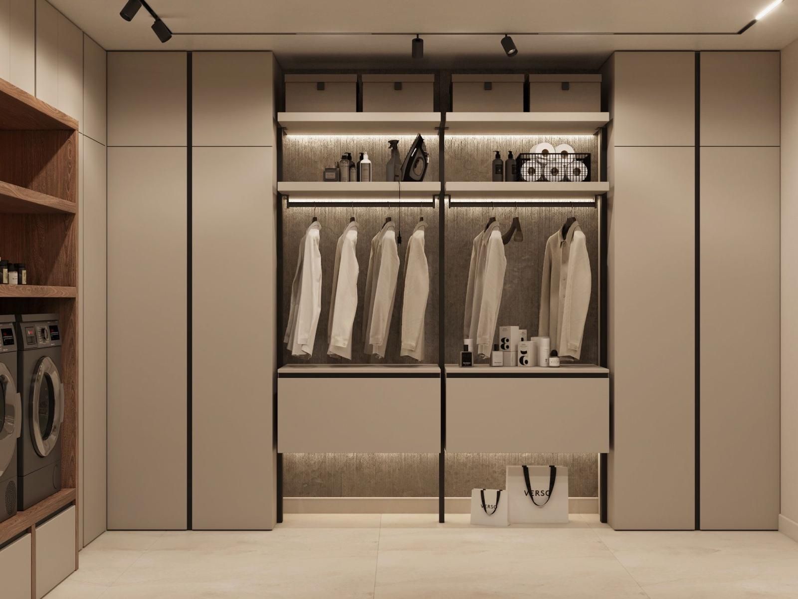 Un vestidor con una lavadora y secadora al fondo.