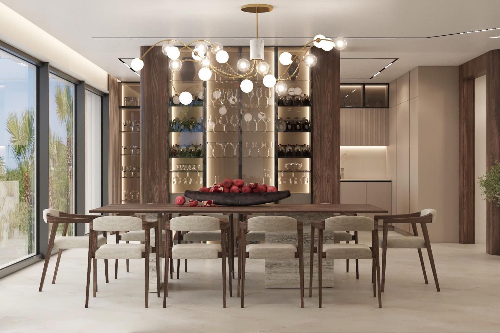 Un comedor con una mesa larga y sillas y un bol con manzanas encima.