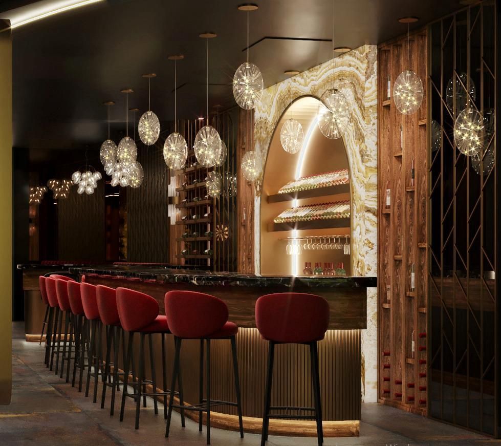 Un bar con sillas rojas y una encimera de mármol.